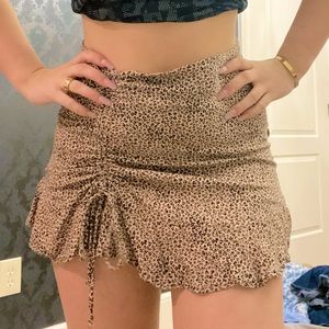 Cutest, cheetah ruffle skirt with toe scrunch bow on left side.